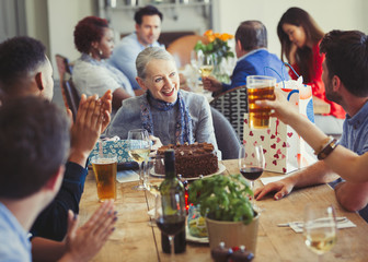 Woman enjoying birthday with friends at restaurant table
