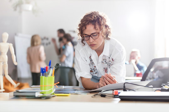 Focused female design professional planning in office