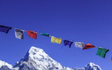Buddhist Shrine Mountain with prayer flags over the blue sky.