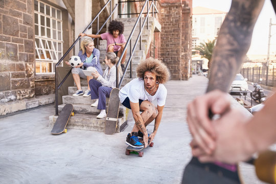 Friends skateboarding and hanging out around urban steps