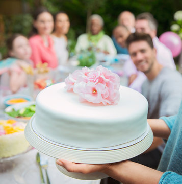 Close up white fondant cake with pink flowers