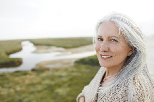Portrait smiling senior woman on beach