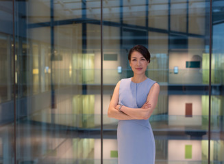 Portrait confident businesswoman in modern office atrium