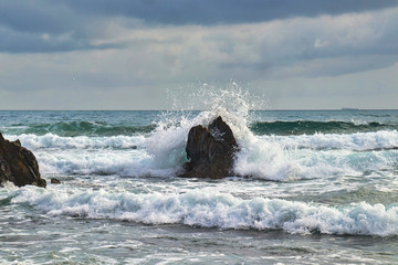 Strong waves in the sea hitting the rocks of the coast