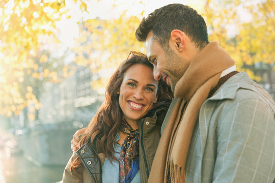 Portrait smiling, affectionate couple on autumn street