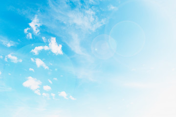 Naklejka na ściany i meble Beautiful white small soft fluffy clouds on a blue sky background, sky with sun glare