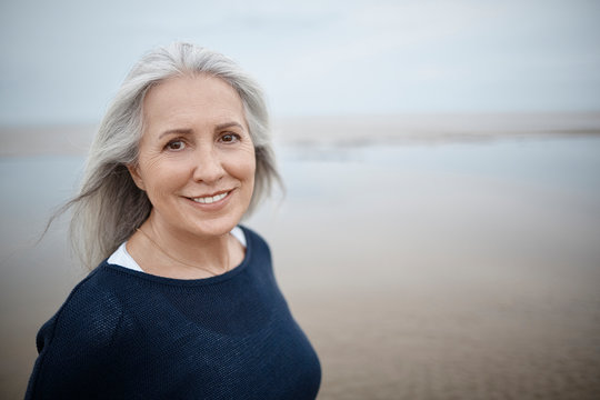 Portrait smiling senior woman on beach