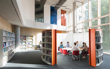 Business people meeting at round table in open plan library