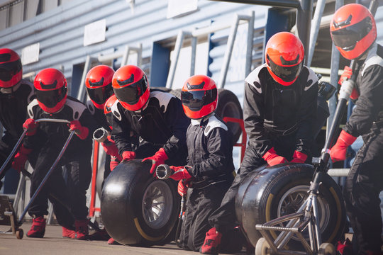 Pit crew ready with tires in formula one pit lane