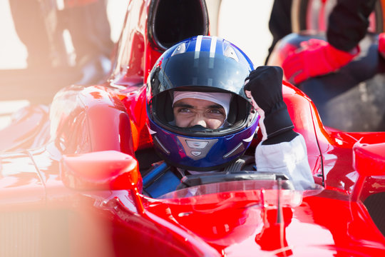 Formula One Race Car Driver In Helmet Gesturing, Celebrating Victory