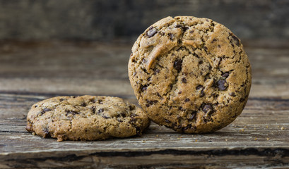 Two Freshly Baked Chocolate Cookies on Rustic Wooden Table. Sweet Biscuits. Homemade pastry.