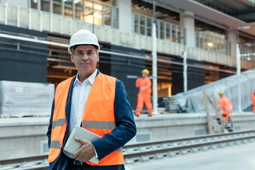 Portrait confident engineer with digital tablet at construction site