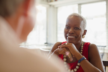 Smiling senior woman dining at restaurant