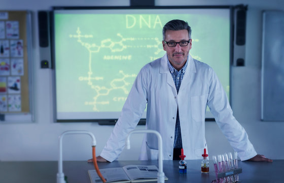 Portrait male science teacher teaching DNA lesson at projection screen