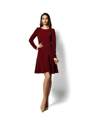 Young beautiful woman posing in new fashion casual dark purple red winter dress happy smiling walking