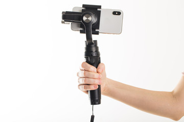 woman hand and gimbal with phone on white background