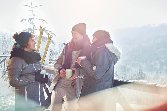 Skier Friends Talking, Drinking Coffee And Hot Cocoa Apres-ski