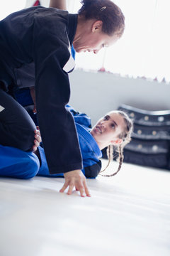 Determined, tough women practicing judo in gym