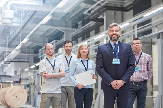 Portrait confident business owner supervisors in fiber optics factory