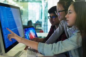 Students programming at computer in computer lab classroom