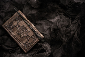 Old book with spells and magic wand on gray background with witch rag. Copy space for text - 315211585