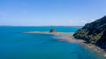 Fototapeta premium Aerial View from the Beach, Ocean, Green Trees of Wenderholm Regional Park in New Zealand - Auckland Area
