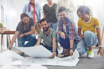 Artists viewing sketches in art class studio