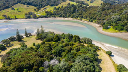 Fototapeta na wymiar Aerial View from the Beach, Ocean, Green Trees of Wenderholm Regional Park in New Zealand - Auckland Area