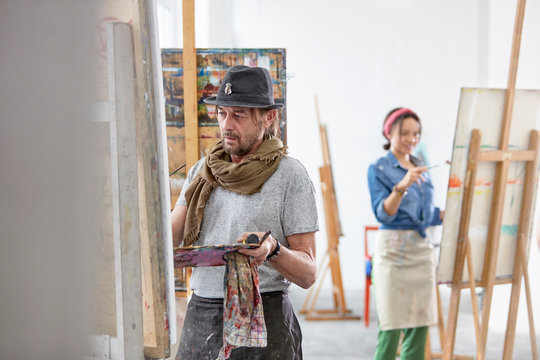 Artists painting in art class studio