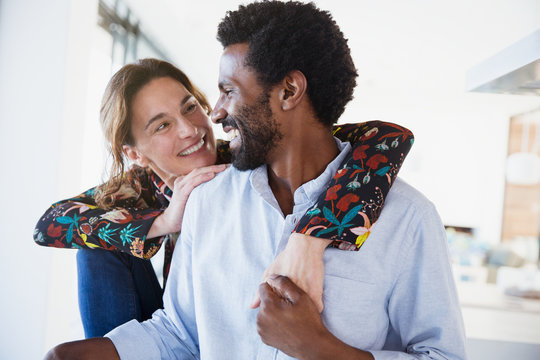Affectionate multi-generation couple hugging