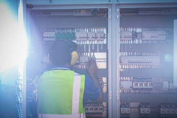 Engineer working at control panel in factory