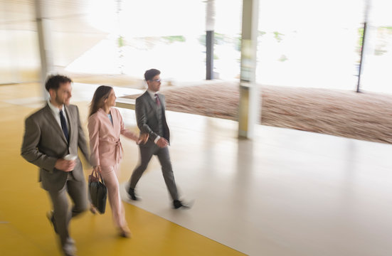 Business people walking in office lobby