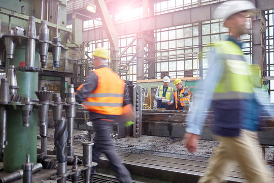 Workers walking and meeting in factory