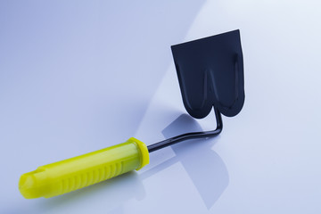 Short garden hoe with yellow handle close-up. White isolated backgrouond.