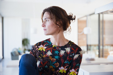 Serious, pensive brunette woman looking away