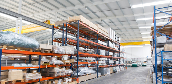 Pallets and equipment on shelves in warehouse