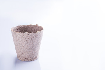 Biodegradable plant pot. Growing container cup for plant isolated on white background.