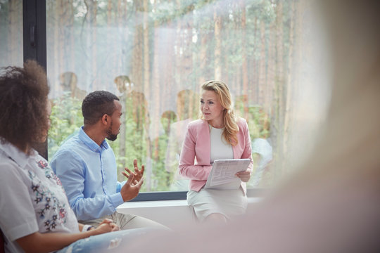 Therapist listening to man talking in group therapy session