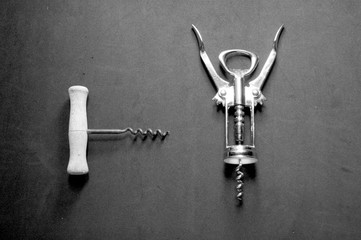 View from above of a pair of manual uncorkers on a black surface