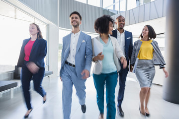 Business people walking in office lobby