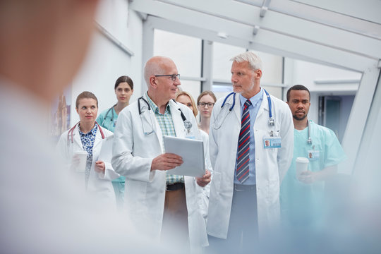 Doctors and nurses walking in hospital corridor