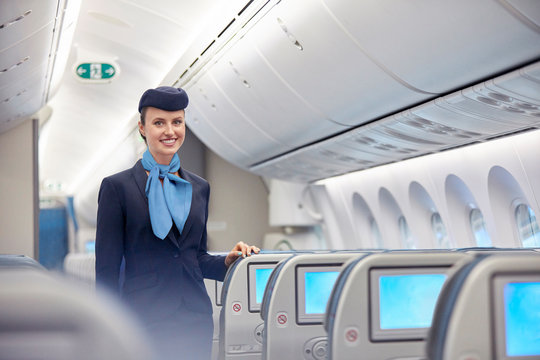 Portrait smiling, confident female flight attendant on airplane