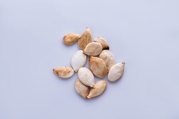 Bunch of raw pumpkin seeds. White isolated background.