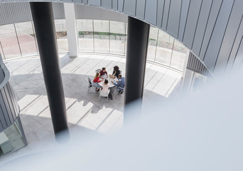 Business people meeting at table in modern office atrium