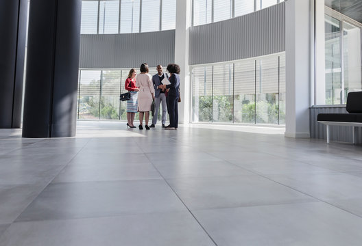 Business People Talking In Modern Office Lobby