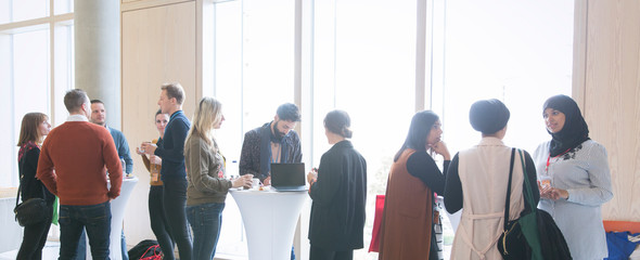 Business people networking, talking at conference