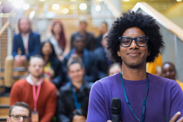 Portrait confident male speaker with microphone