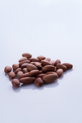 Heap of brown beans. White isolated background.