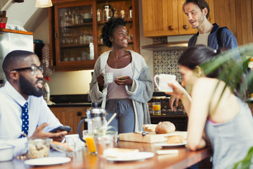 Friend roommates enjoying breakfast in kitchen