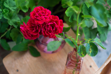 Bunch of red roses in a purple vase